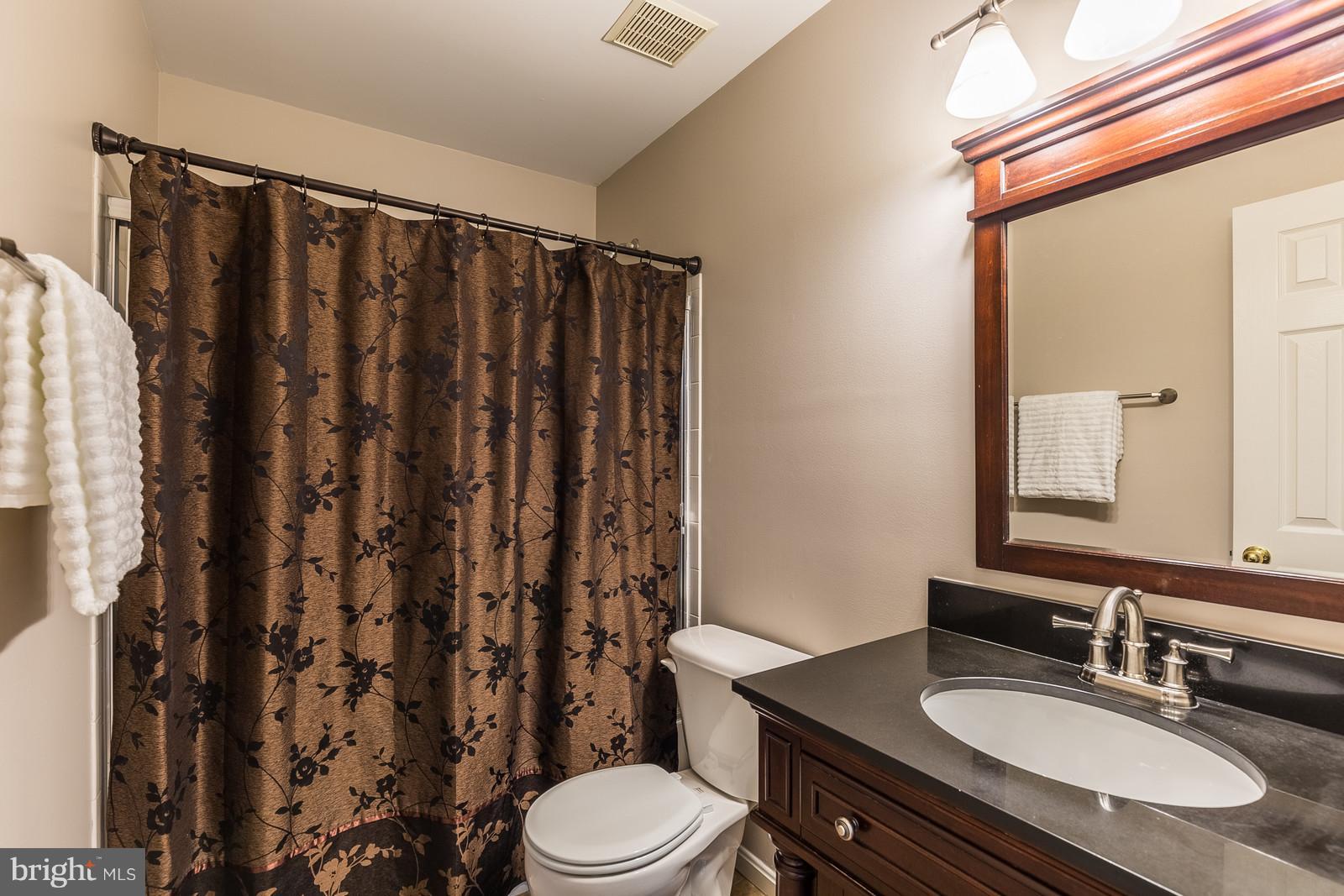 43553 Dempsey Lane Chantilly, VA 20152 - Photo 21 of 30 a bathroom with a granite countertop sink toilet and shower