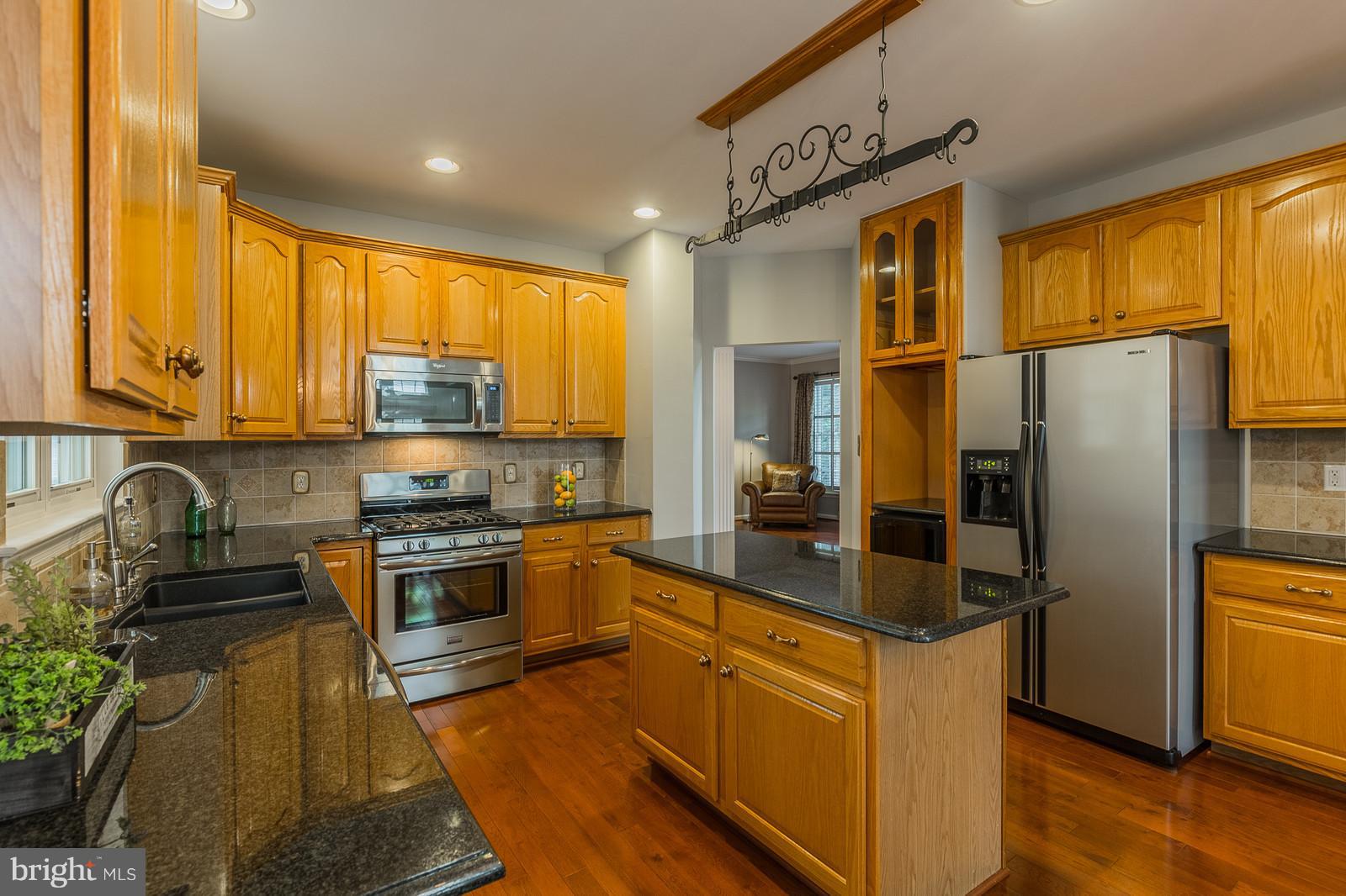43553 Dempsey Lane Chantilly, VA 20152 - Photo 7 of 30 a kitchen with stainless steel appliances granite countertop a refrigerator a stove top oven a sink and dishwasher
