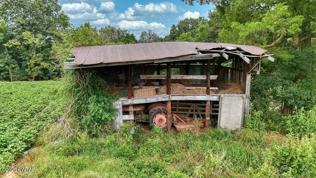 an aerial view of a house with backyard space and deck