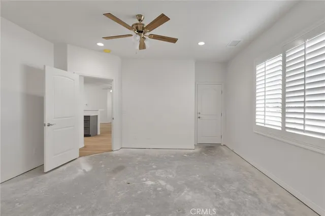an empty room with windows and closet
