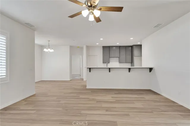 a view of kitchen with granite countertop cabinets and a ceiling fan