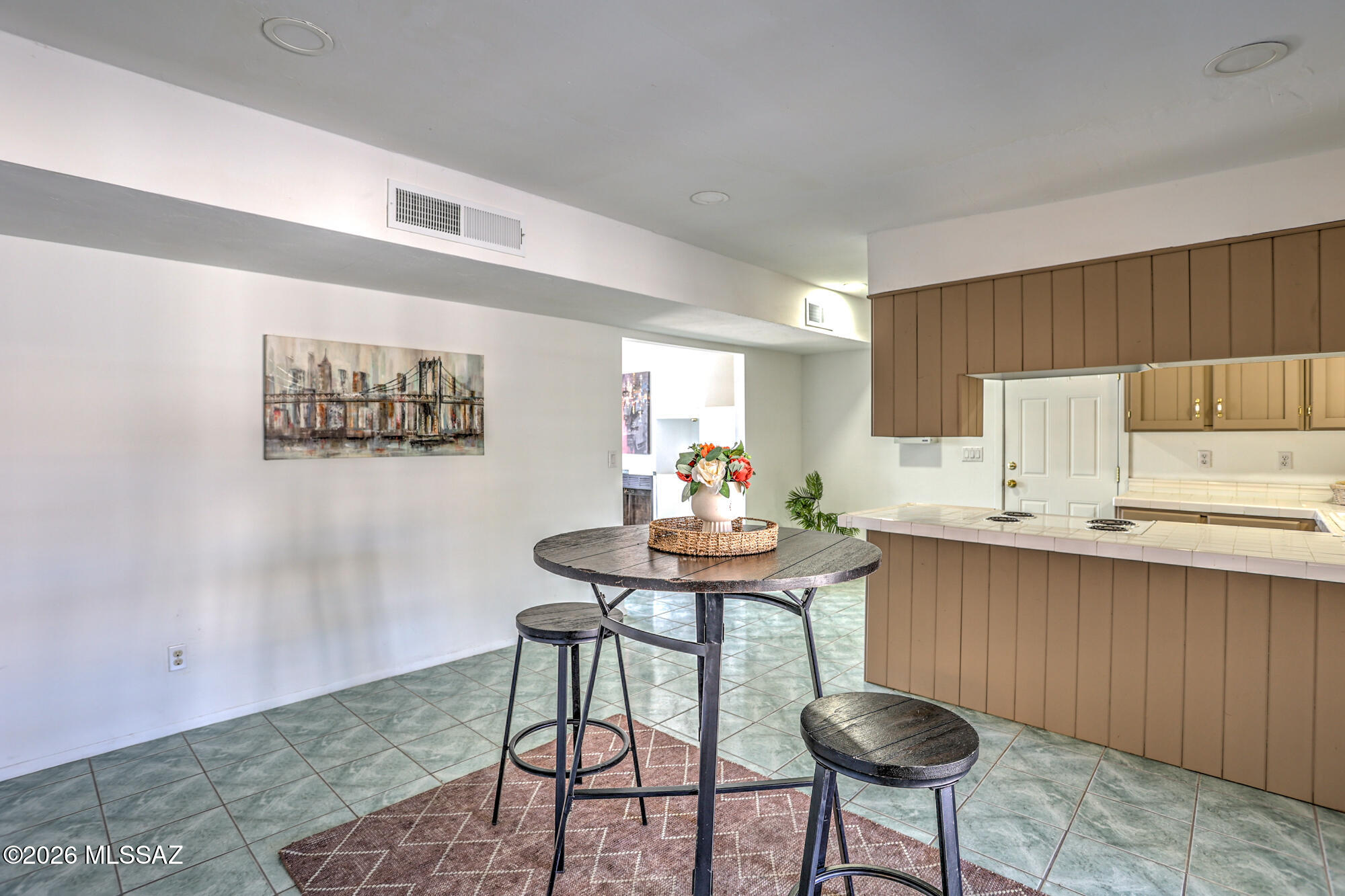 4400 West Ina Road Tucson, AZ 85741 - Photo 18 of 43 a kitchen with stainless steel appliances a table and chairs in it