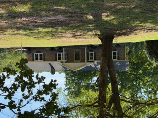 This charming residence is nestled amidst lush greenery, offering a peaceful and private setting.