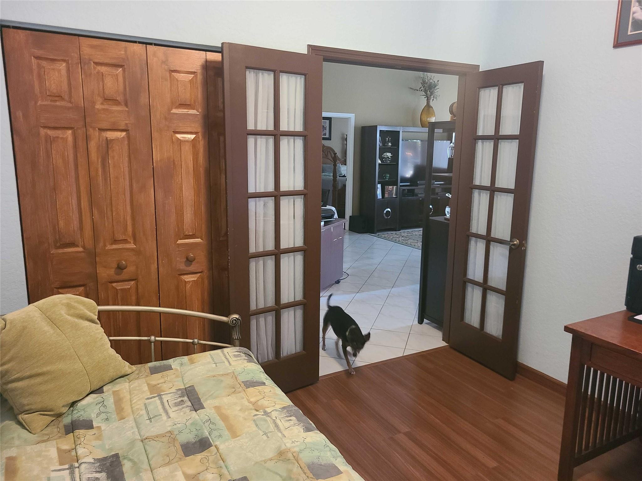 Undisclosed Address Lake Worth, FL 33467 - Photo 14 of 21 a bedroom with a bed and wooden floor