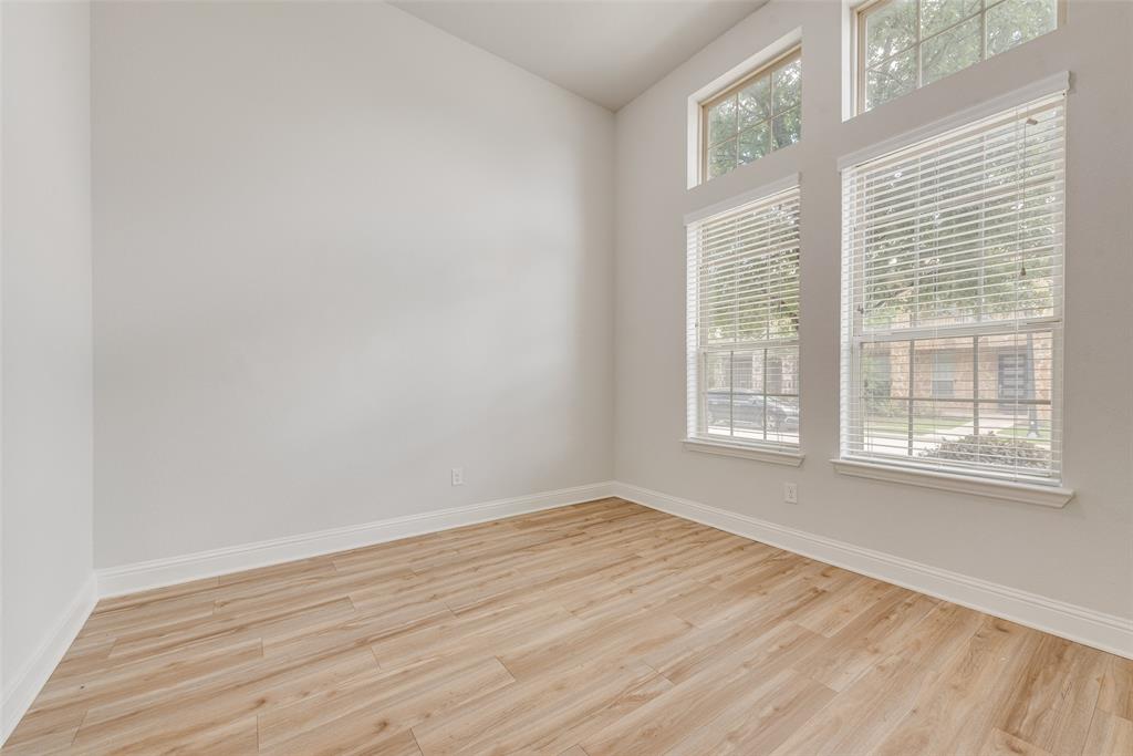 628 Ansley Way Allen, TX 75013 - Photo 10 of 20 Spacious room featuring light wood-finish flooring, tall ceilings, and abundant natural light from multiple windows
