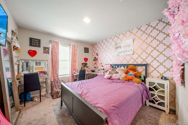 a bed room with a bed and a chair