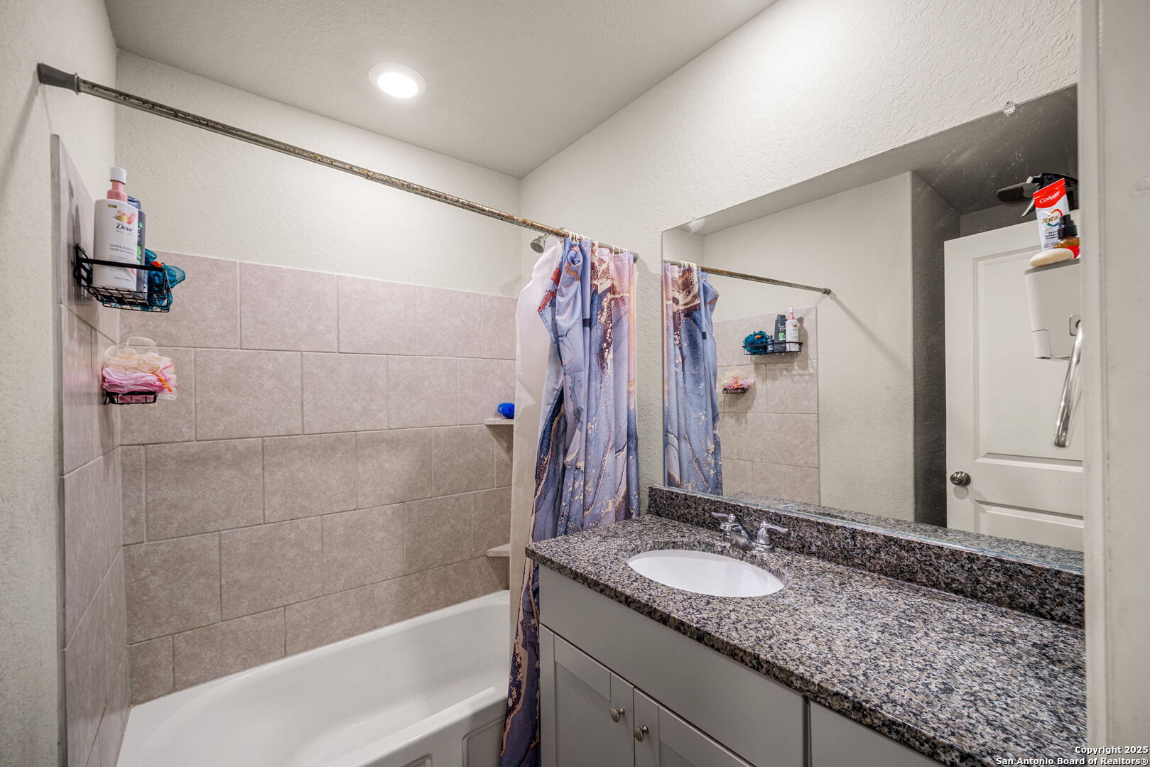31646 Untrodden Way Bulverde, TX 78163 - Photo 20 of 36 a bathroom with a granite countertop sink a shower and a mirror