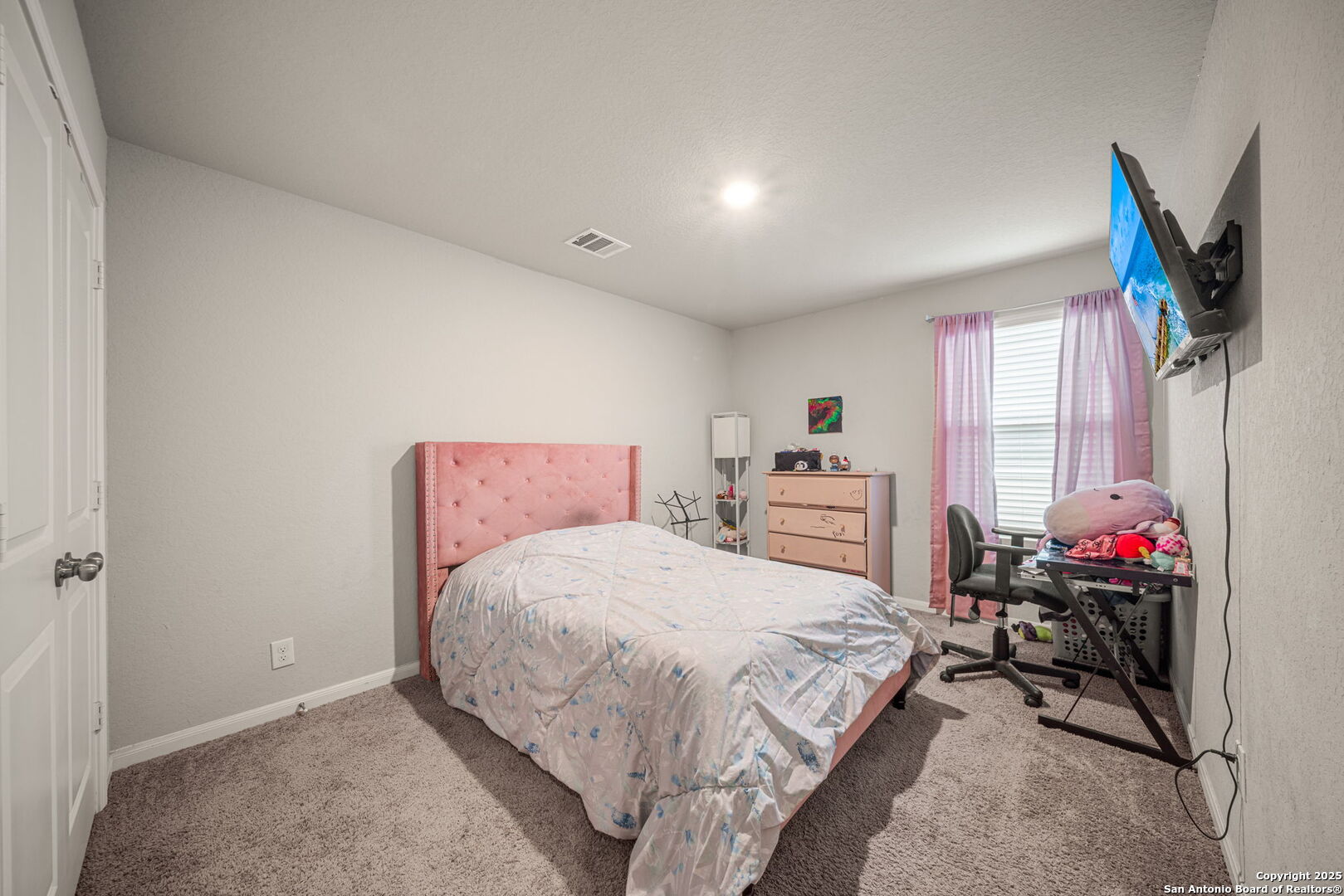 31646 Untrodden Way Bulverde, TX 78163 - Photo 21 of 36 a bedroom with a bed and a chandelier