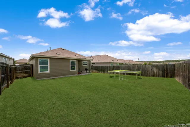 a view of a house with a backyard
