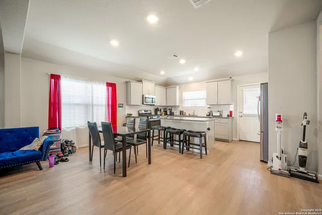 a view of a dining room with furniture and chandelier