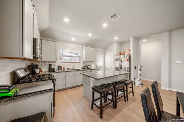 a kitchen with counter top space appliances and cabinets