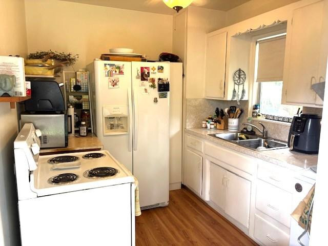 44 Southwest 5th Street Dania Beach, FL 33004 - Photo 18 of 43 a kitchen with a refrigerator a stove and wooden floor