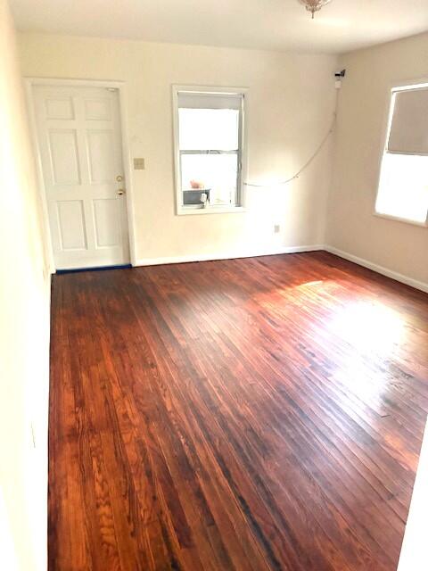 44 Southwest 5th Street Dania Beach, FL 33004 - Photo 4 of 43 an empty room with wooden floor and windows