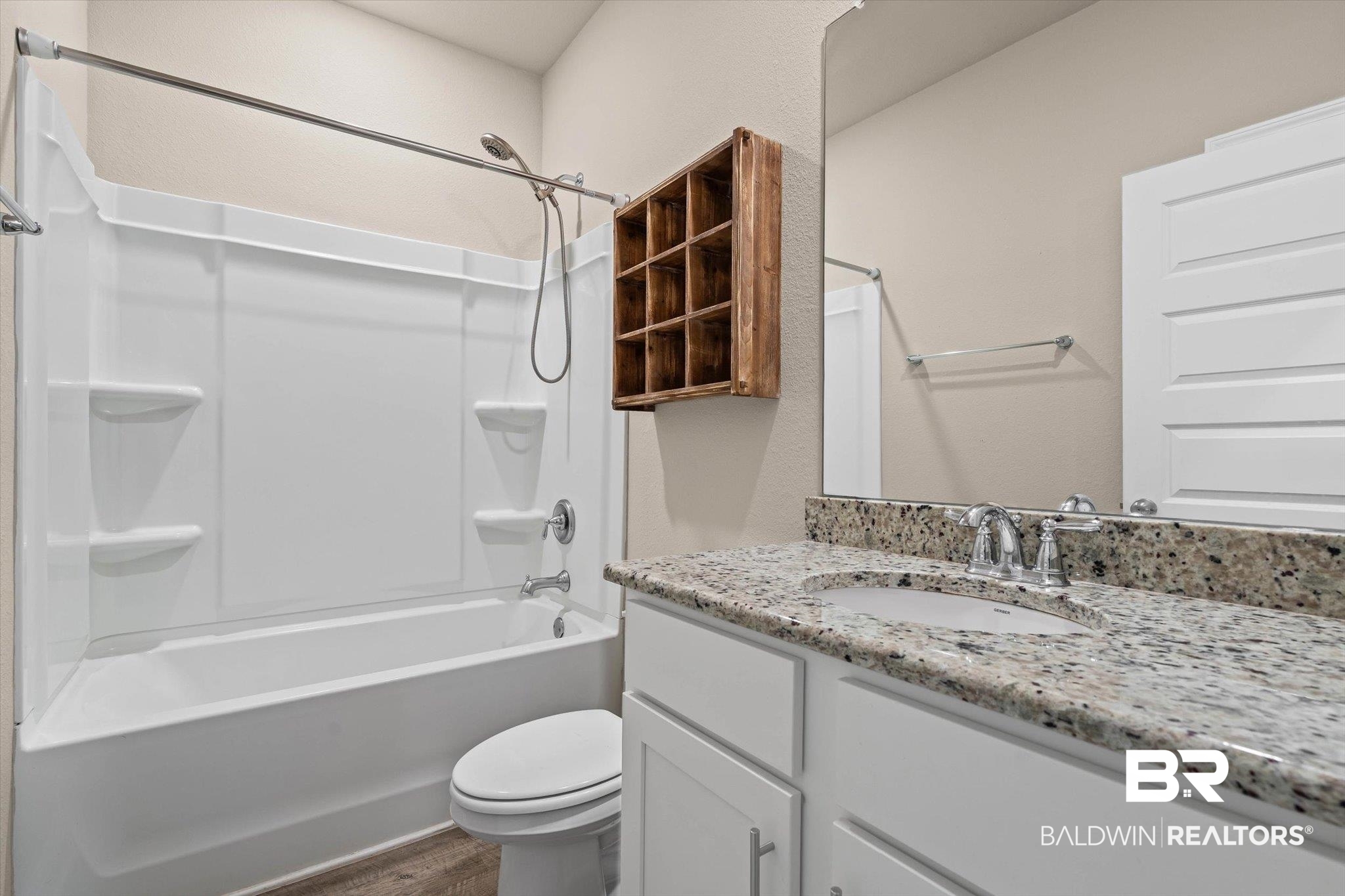22976 Lieutenant Avenue Foley, AL 36535 - Photo 13 of 30 Bathroom featuring bathtub / shower combination, vanity, and dark wood-type flooring