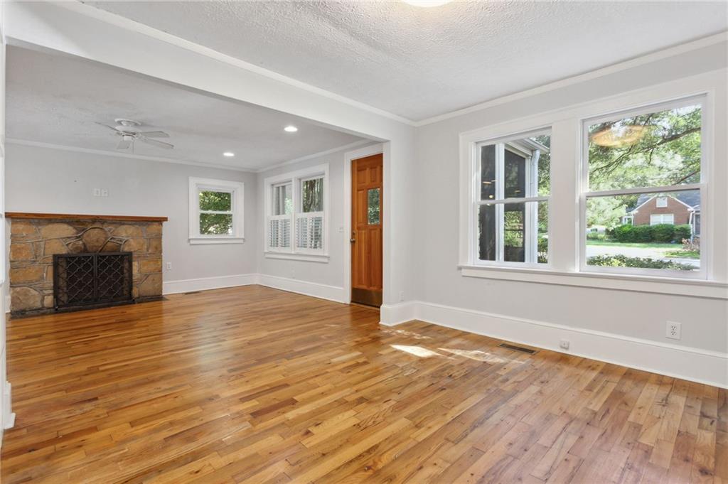 385 Sunset Drive Athens, GA 30606 - Photo 10 of 48 a view of empty room with wooden floor and fireplace