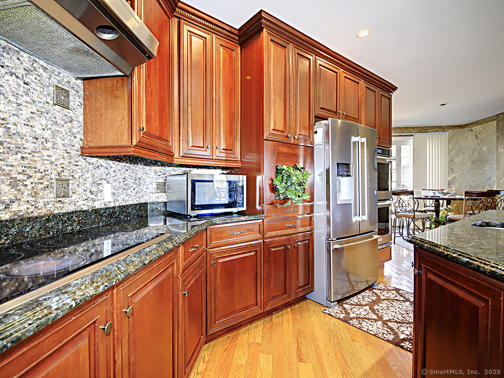 114 Wheeler Farm Road Watertown, CT 06795 - Photo 12 of 23 a kitchen with stainless steel appliances granite countertop a refrigerator and a sink