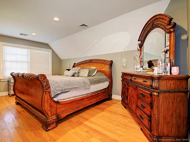 a bedroom with furniture and a window