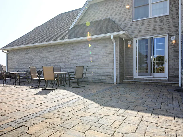 a outdoor space with a table and chairs