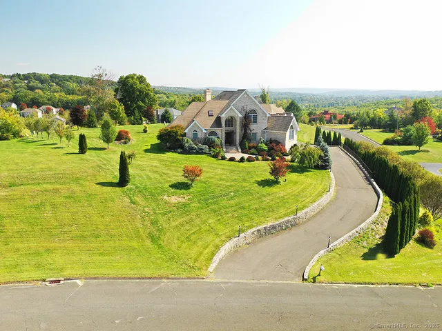 an aerial view of residential houses with outdoor space and parking