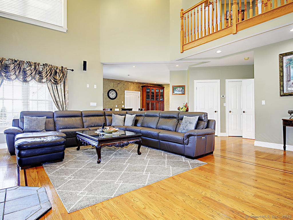 114 Wheeler Farm Road Watertown, CT 06795 - Photo 7 of 23 a living room with furniture and a wooden floor