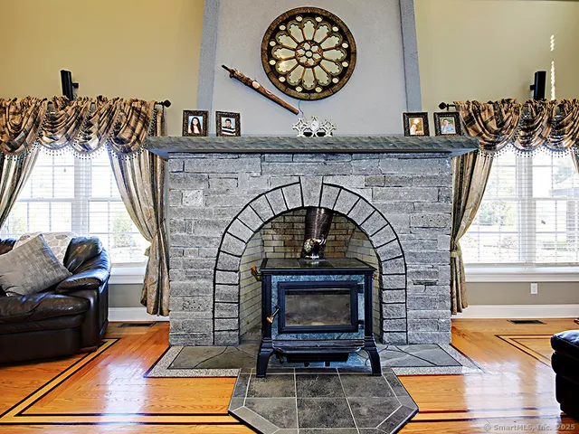 view of hall way with furniture and a fireplace