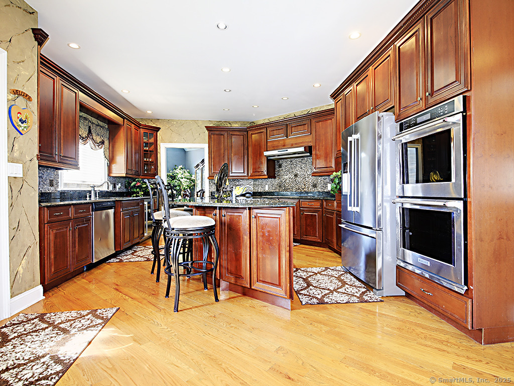 114 Wheeler Farm Road Watertown, CT 06795 - Photo 9 of 23 a kitchen with stainless steel appliances kitchen island granite countertop a sink and cabinets