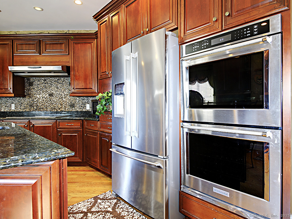 114 Wheeler Farm Road Watertown, CT 06795 - Photo 10 of 23 a kitchen with stainless steel appliances granite countertop a stove microwave and refrigerator