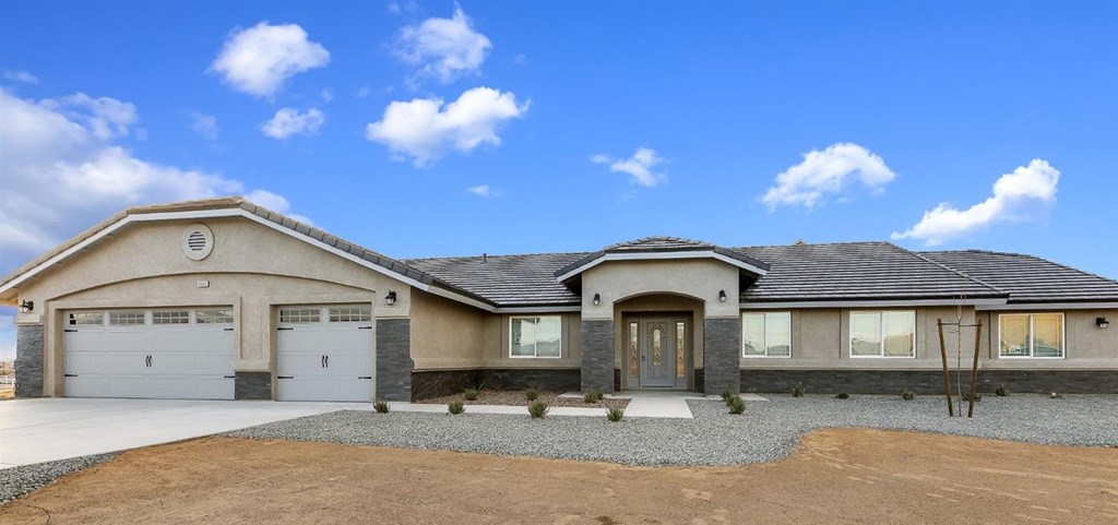 16896 Joshua Road Apple Valley, CA 92308 - Photo 1 of 1 a front view of a house with a yard