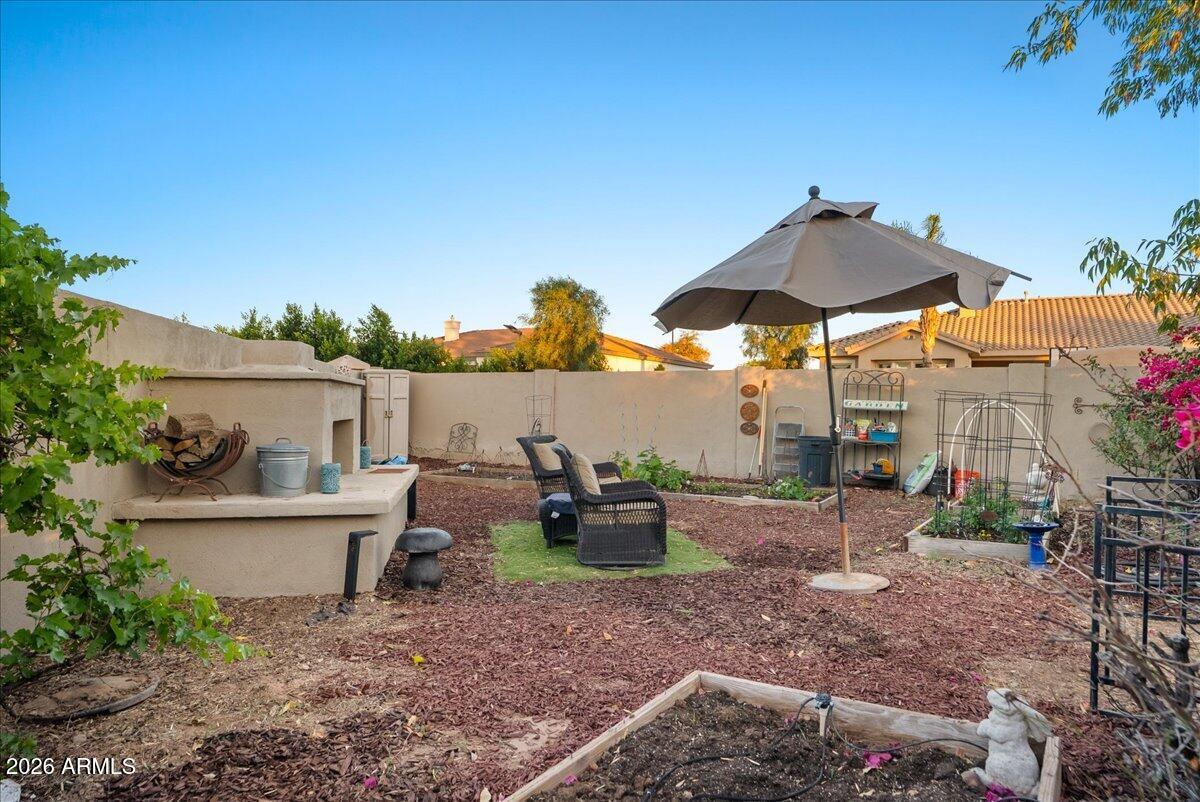 6427 South Magic Court Gilbert, AZ 85298 - Photo 51 of 71 a view of a patio with chairs and potted plants