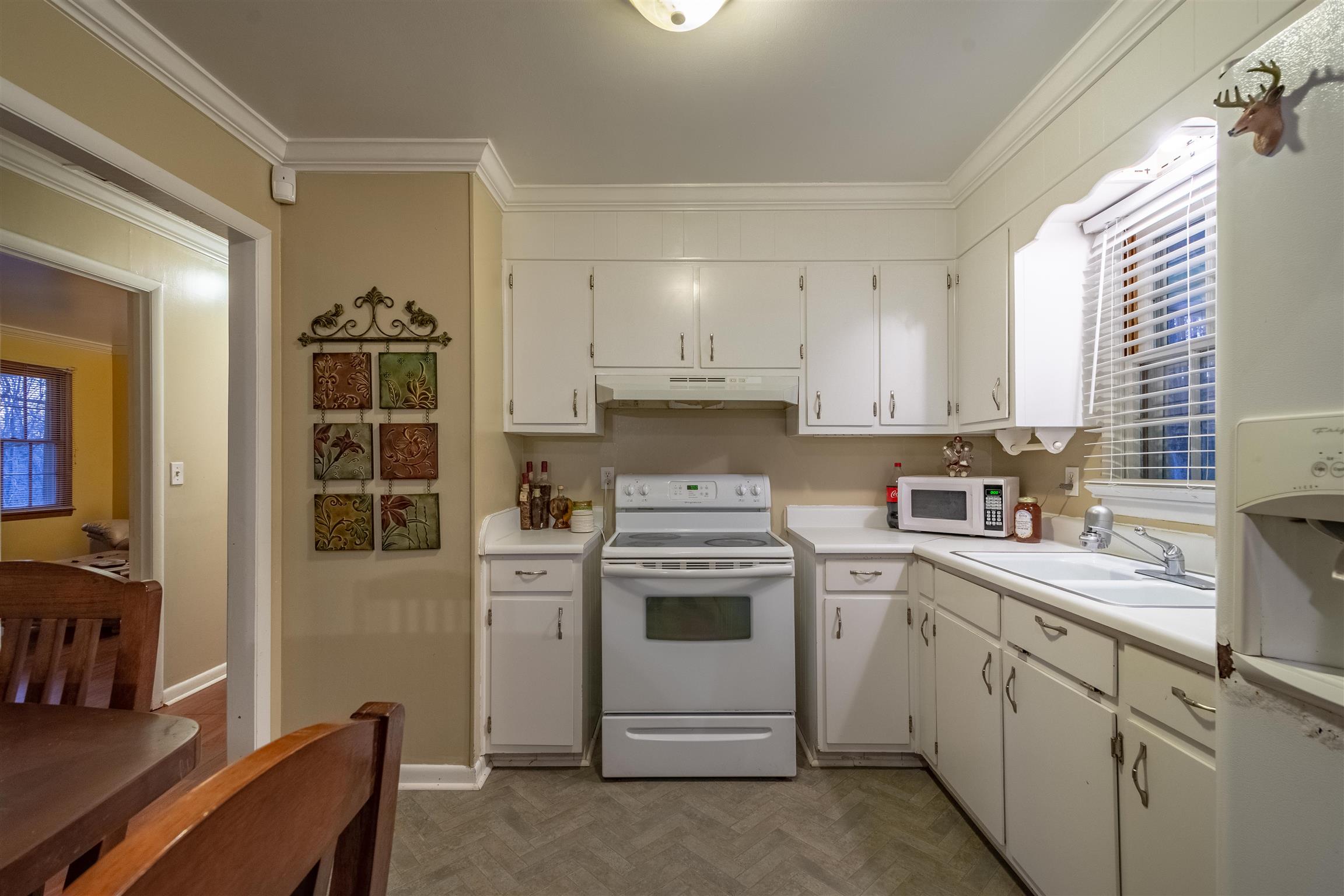 1666 Prospect Elkton Road Prospect, TN 38477 - Photo 8 of 30 a kitchen with a stove white cabinetry and a sink