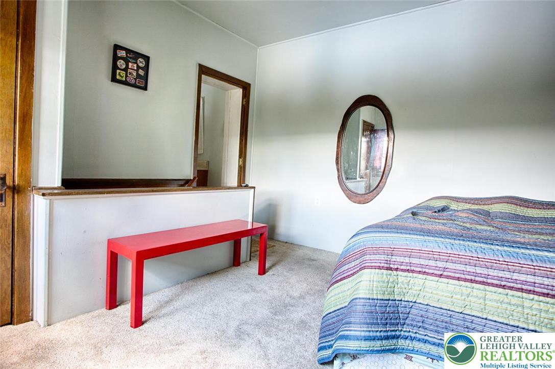 5449 Depues Road Bangor, PA 18013 - Photo 29 of 39 a bedroom with a bed and a mirror