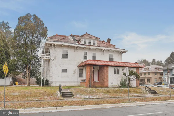 a front view of a house with a garden