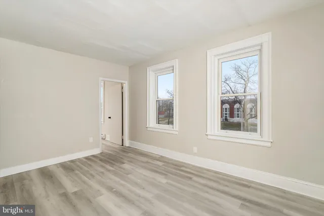 a room with a bench and a white door
