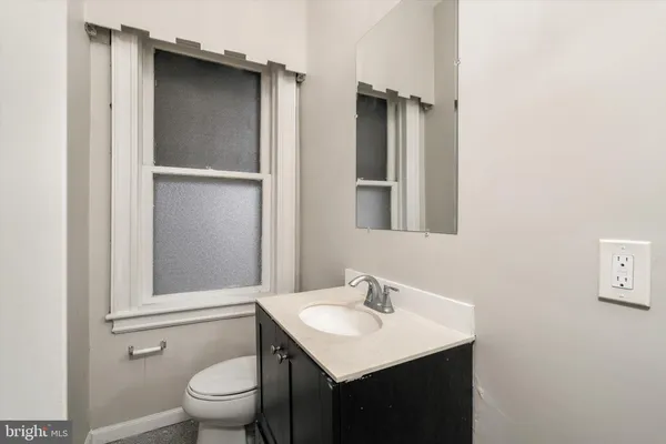 a bathroom with a sink toilet and mirror