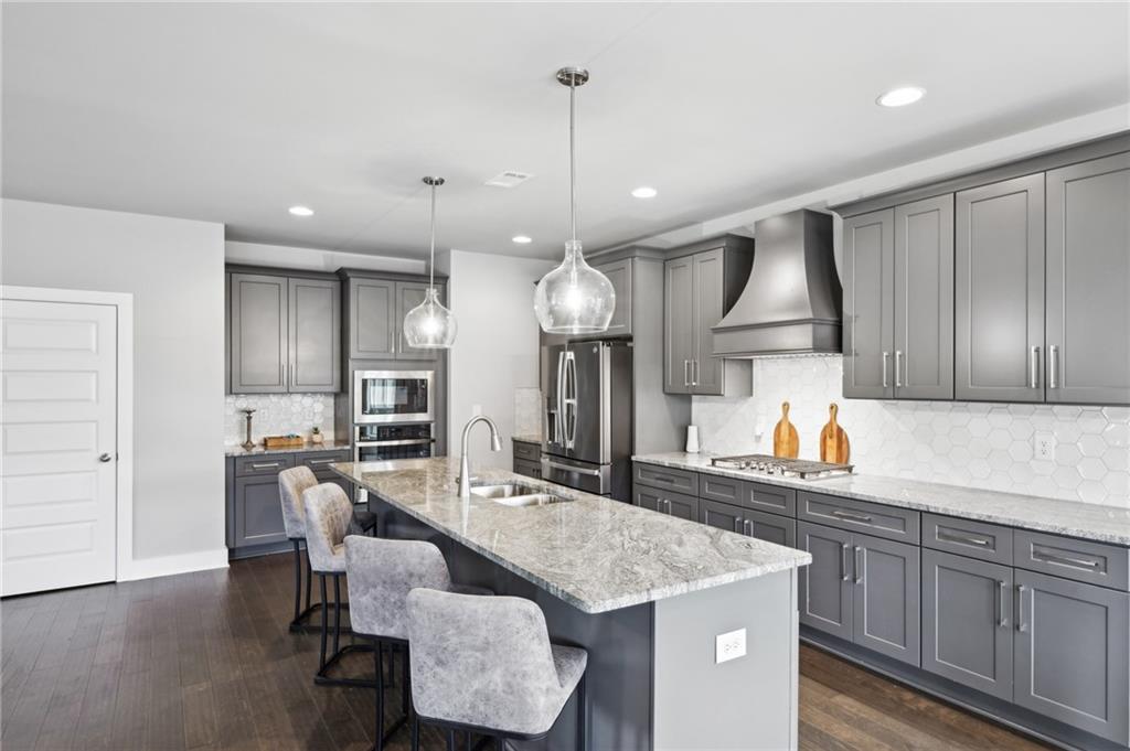 3143 Stonegate Drive Atlanta, GA 30331 - Photo 13 of 32 a kitchen with granite countertop kitchen island stainless steel appliances a sink and a refrigerator