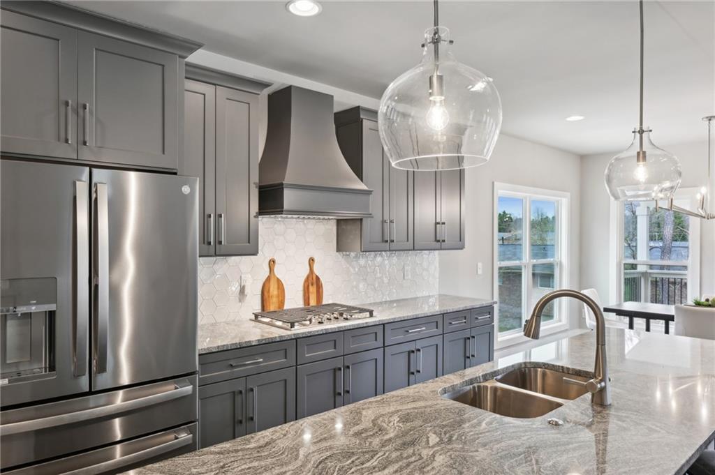 3143 Stonegate Drive Atlanta, GA 30331 - Photo 14 of 32 a kitchen with stainless steel appliances granite countertop a sink refrigerator and cabinets