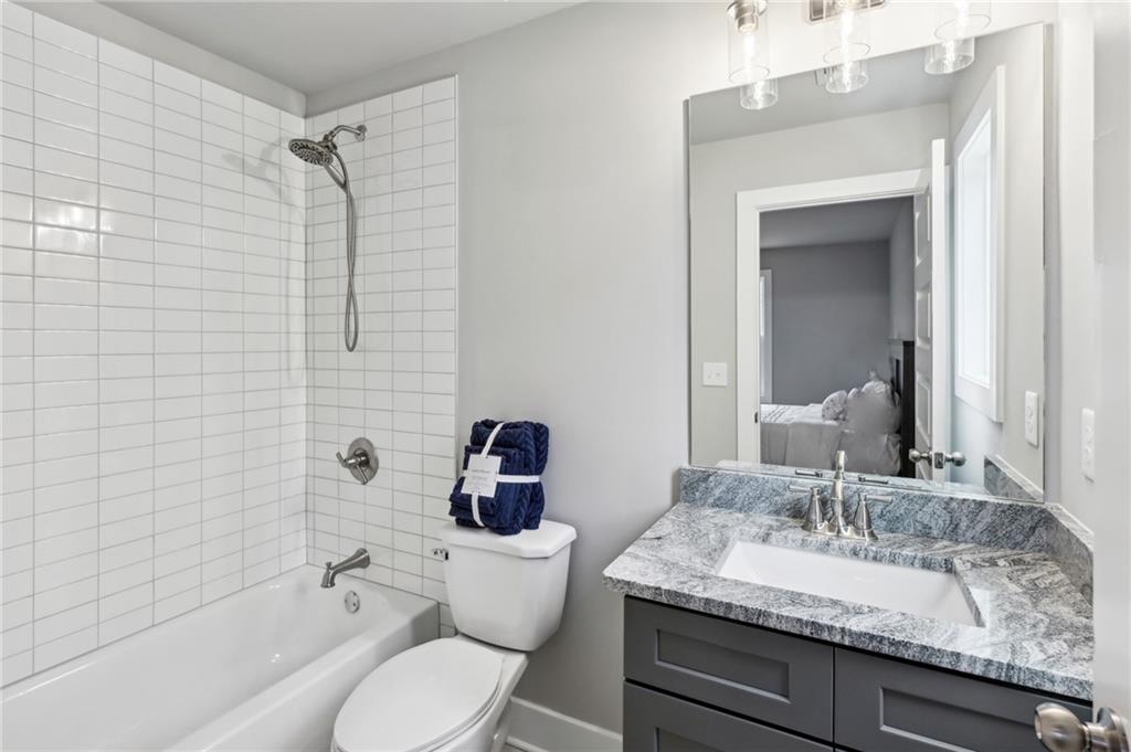 3143 Stonegate Drive Atlanta, GA 30331 - Photo 27 of 32 a bathroom with a granite countertop sink mirror toilet and bathtub