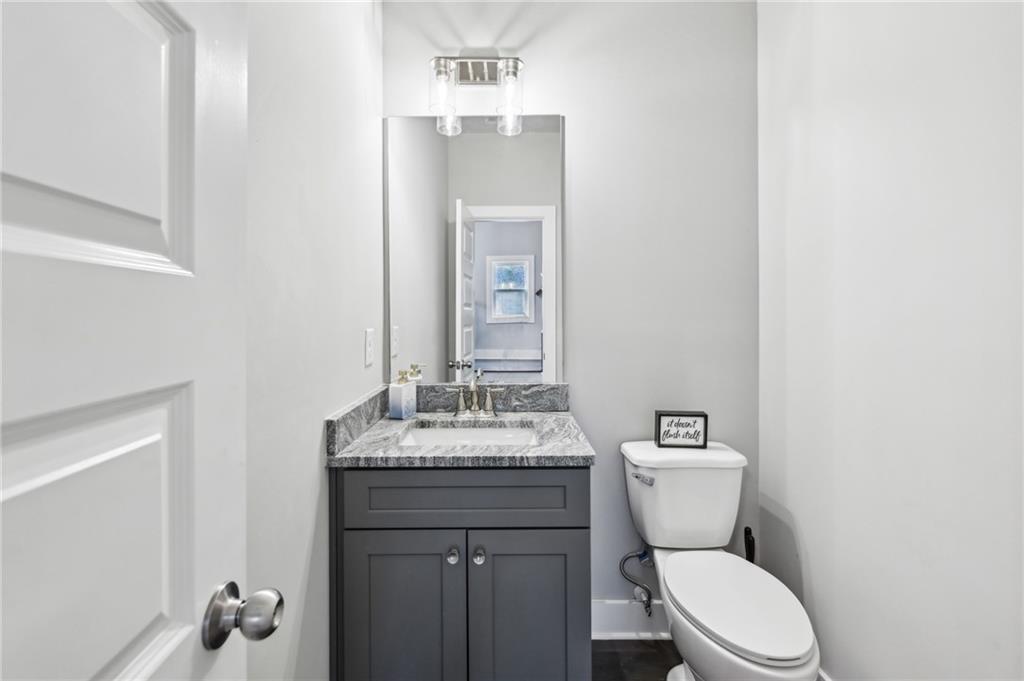 3143 Stonegate Drive Atlanta, GA 30331 - Photo 29 of 32 a bathroom with a granite countertop toilet sink and mirror