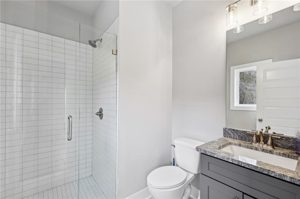 3143 Stonegate Drive Atlanta, GA 30331 - Photo 30 of 32 a bathroom with a granite countertop sink toilet and shower