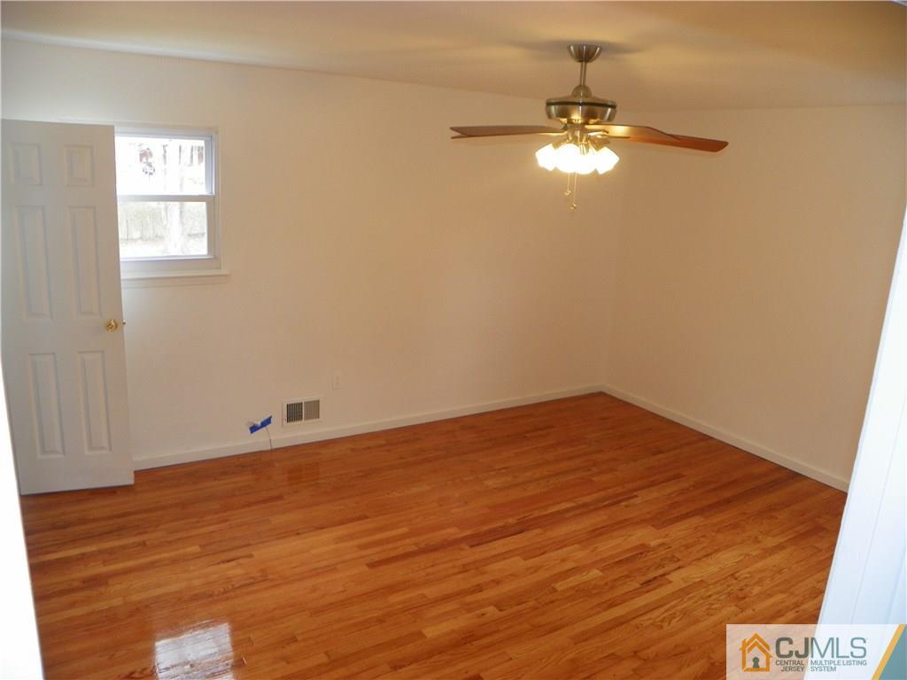 27 Greenwich Road Edison, NJ 08820 - Photo 14 of 23 a view of a room with wooden floor and a ceiling fan