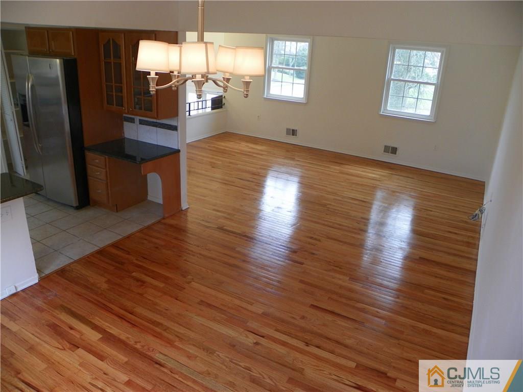 27 Greenwich Road Edison, NJ 08820 - Photo 8 of 23 a view of a living room and kitchen with furniture wooden floor and windows