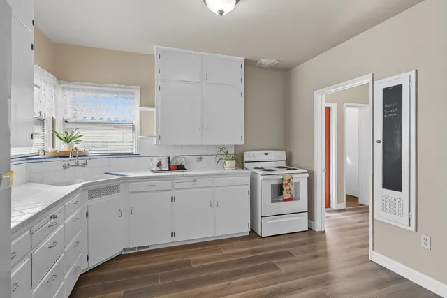 a view of cabinets with wooden floor and window