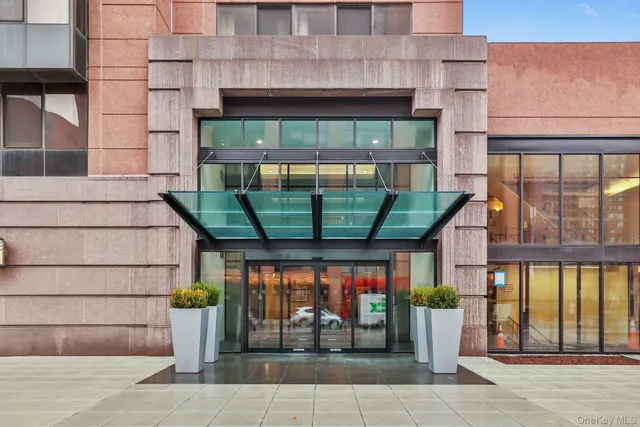 a front view of a building with glass windows and door