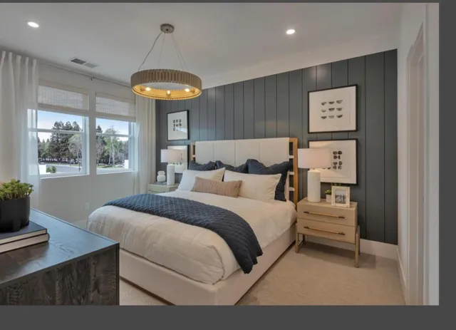 a bedroom with a bed and a chandelier