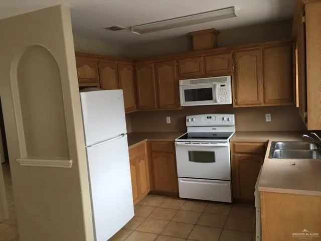 a kitchen with a refrigerator sink and microwave