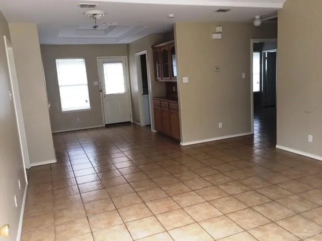 an empty room with windows and closet