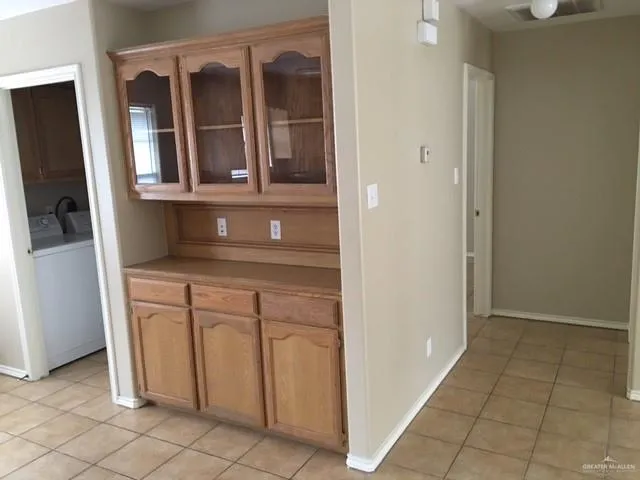 a kitchen with a white cabinets and a refrigerator