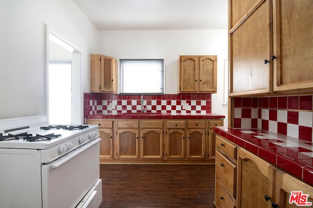 a kitchen with a stove and white cabinets