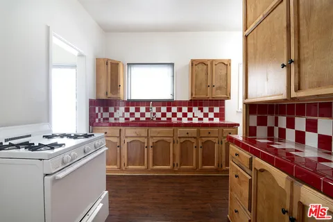 a kitchen with a stove and white cabinets