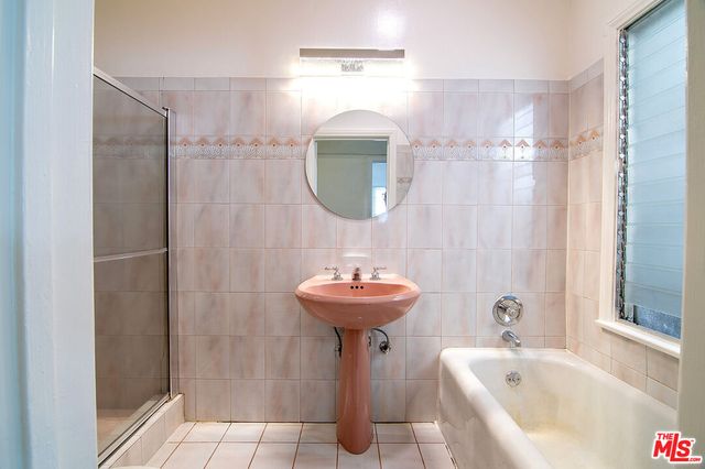 a bathroom with a sink a mirror and a shower